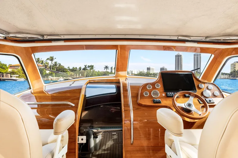 Slide: The Image of Interior view of 2009 Hinckley Runabout 38 yacht, featuring elegant wood finish and modern controls. - 10