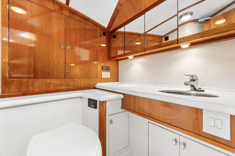 Slide: The Image of Luxurious 2009 Hinckley Runabout 38 bathroom with wood cabinetry and modern fixtures. - 13