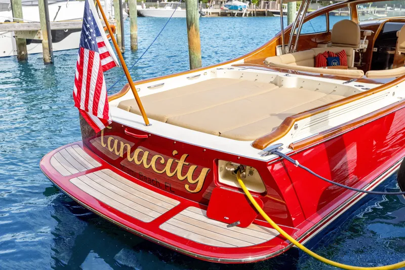 Slide: The Image of 2009 Hinckley Runabout 38 boat with American flag, docked in marina. - 5