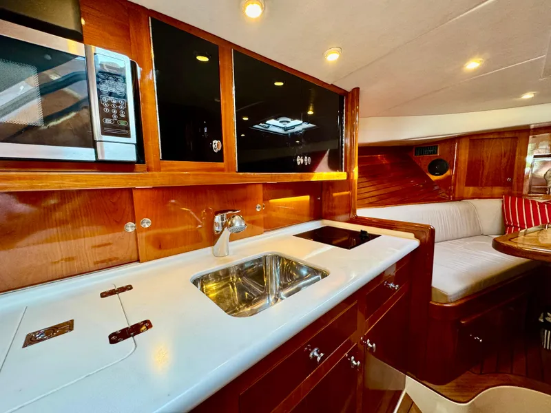 Slide: The Image of Luxurious interior of 2009 Hinckley Runabout 38 with modern kitchen and seating area. - 14