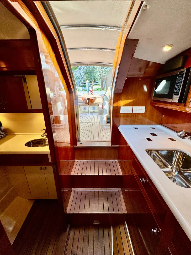 Slide: The Image of Interior of 2009 Hinckley Runabout 38, featuring elegant wood finishes and modern amenities. - 15