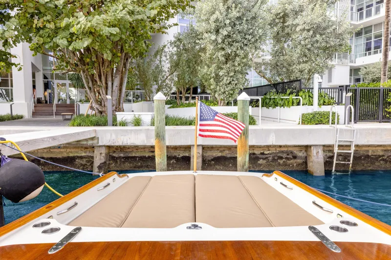 Slide: The Image of 2009 Hinckley Runabout 38 docked, featuring American flag and waterfront view. - 17