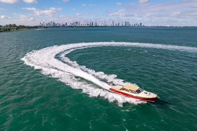 Slide: The Image of Hinckley Runabout 38 (2009) cruising in open water with city skyline in background. - 3