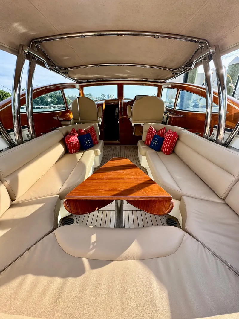 Slide: The Image of 2009 Hinckley Runabout 38 interior with beige seating and wooden table. - 7