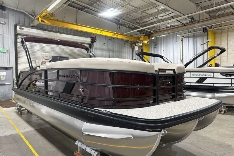 The Image of 2026 Bennington 24 MOFBSF pontoon boat in a warehouse setting. - 1