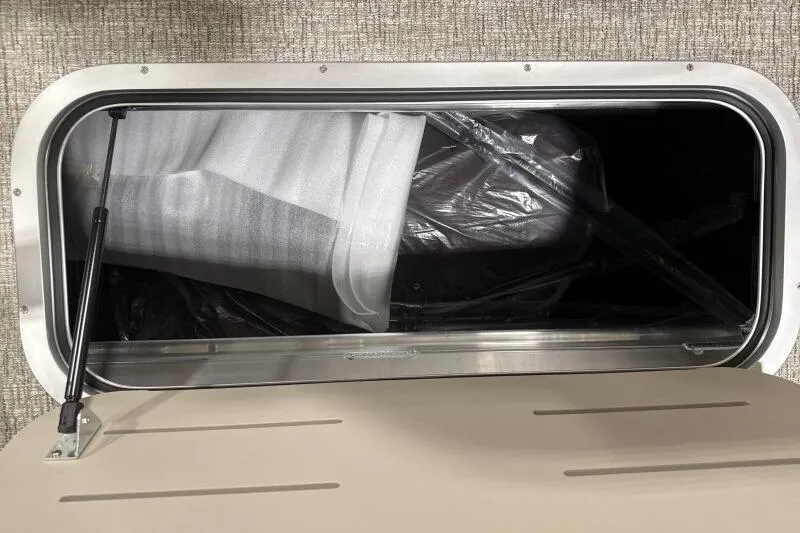 Slide: The Image of Open storage compartment in 2026 Bennington 24 MOFBSF boat, showing interior details. - 13