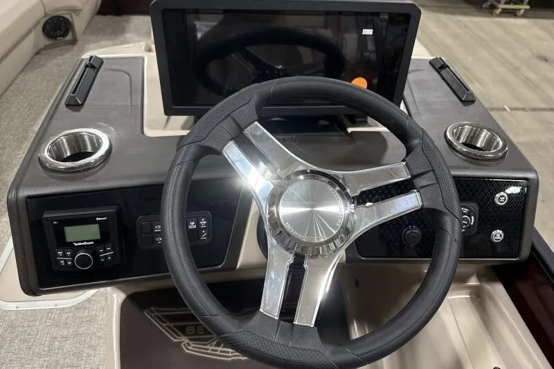 Slide: The Image of Steering console of 2026 Bennington 24 MOFBSF boat with modern controls and cup holders. - 18