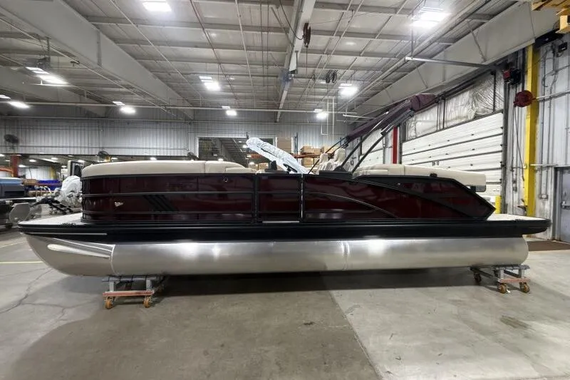 Slide: The Image of 2026 Bennington 24 MOFBSF pontoon boat in a spacious indoor facility. - 4