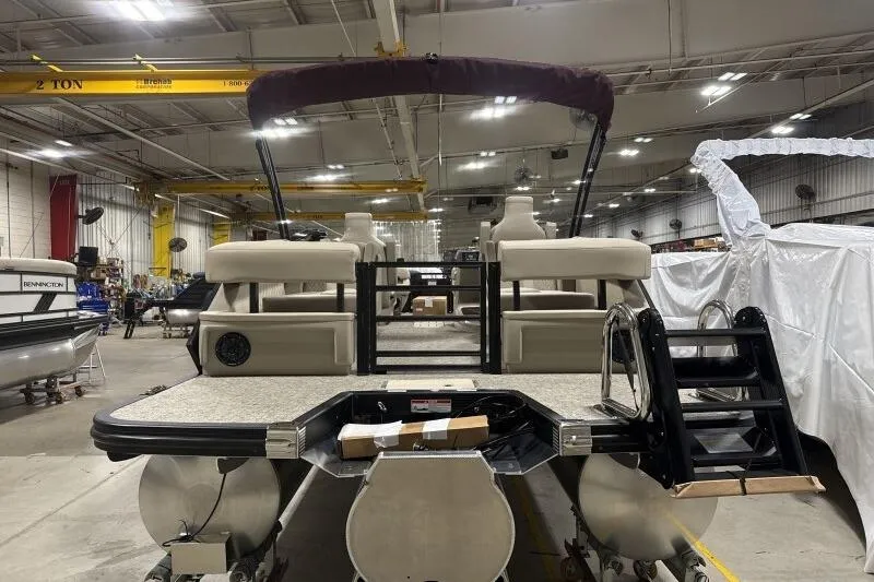 Slide: The Image of 2026 Bennington 24 MOFBSF pontoon boat in a warehouse setting. - 6