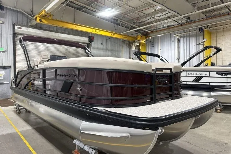 Slide: The Image of 2026 Bennington 24 MOFBSF pontoon boat in a warehouse setting. - 9