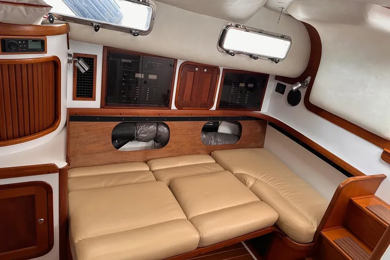 Slide: The Image of Interior of 2001 Legacy Yachts Express with beige seating and wooden accents. - 107
