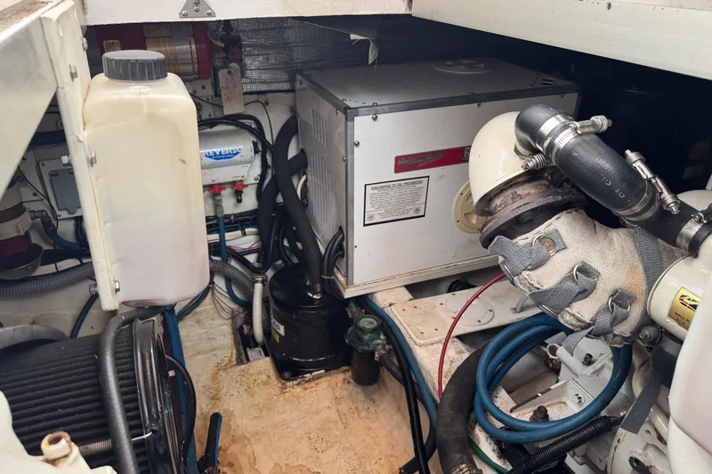 Slide: The Image of Engine room of 2001 Legacy Yachts Express, showcasing mechanical components and wiring. - 91