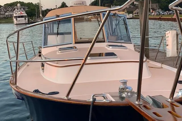 Slide: The Image of 2001 Legacy Yachts Express boat docked in a marina, featuring sleek design and polished railings. - 95