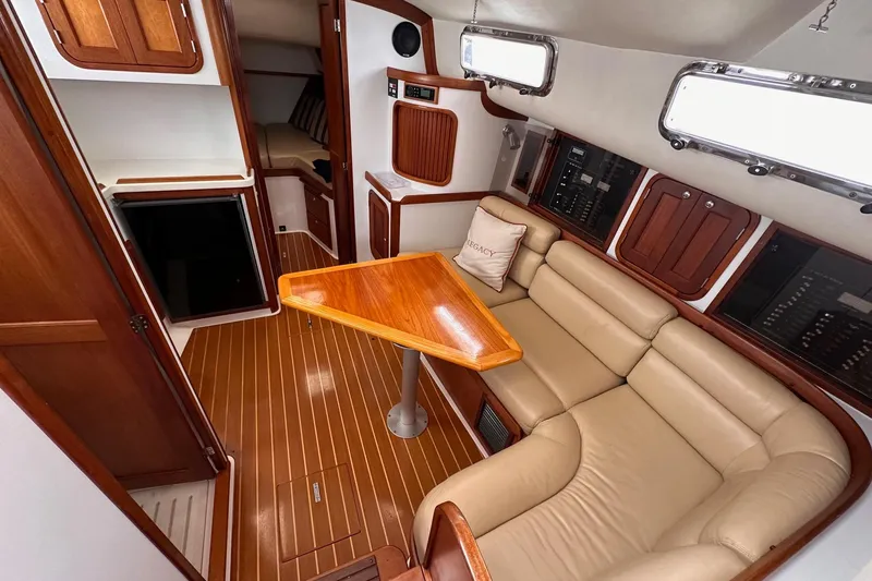 Slide: The Image of Interior of 2001 Legacy Yachts Express with leather seating and wooden table. - 106