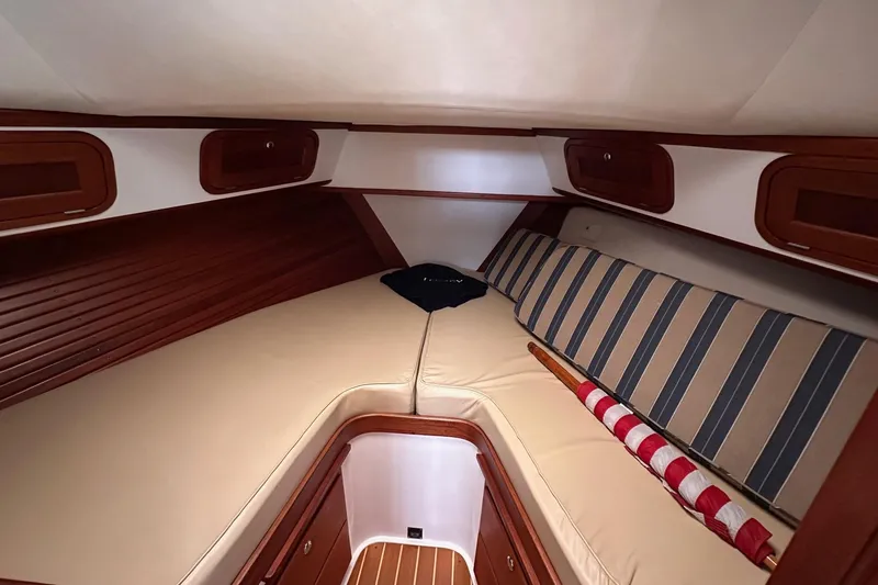 Slide: The Image of 2001 Legacy Yachts Express cabin interior with cozy bedding and wooden accents. - 108