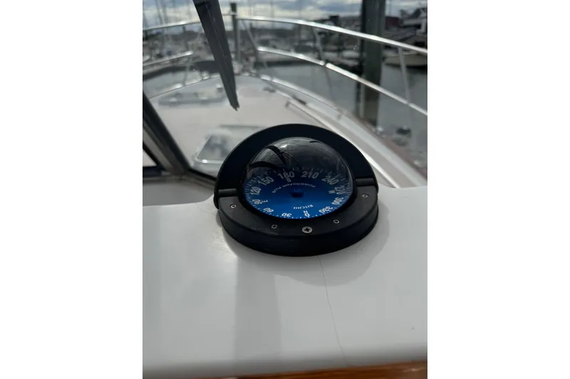 Slide: The Image of Compass on 2001 Legacy Soft Top boat, docked with marina view. - 15