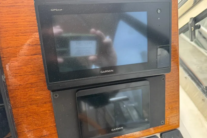 Slide: The Image of Garmin GPS devices on 2001 Legacy Soft Top boat dashboard, mounted on wood panel. - 19