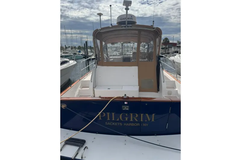 Slide: The Image of 2001 Legacy Soft Top boat docked, featuring "Pilgrim" from Sackets Harbor, NY. - 2