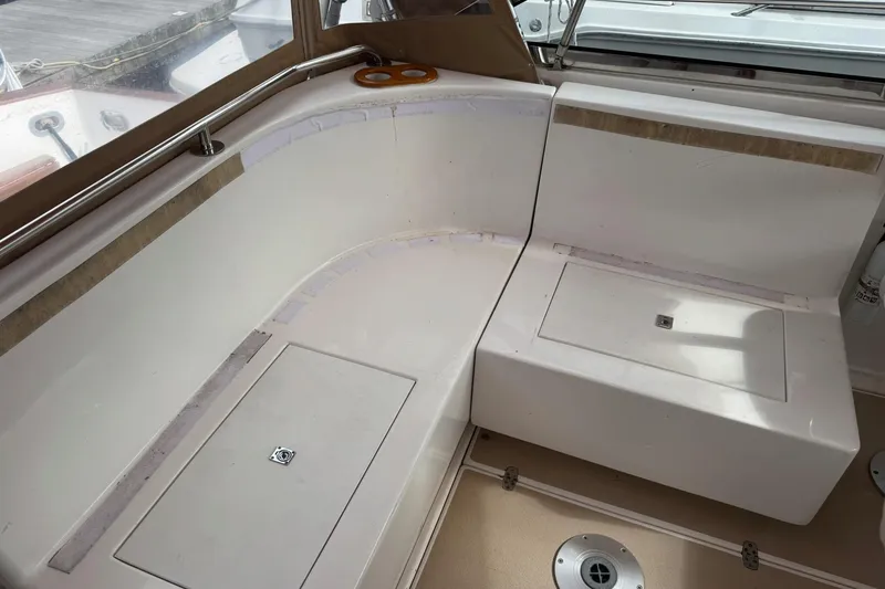 Slide: The Image of 2001 Legacy Soft Top boat interior with white seating and storage compartments. - 22