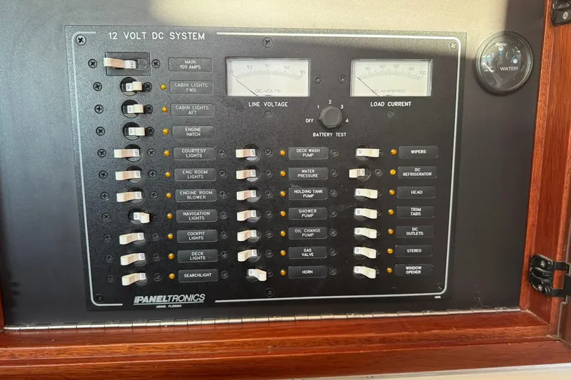 Slide: The Image of 2001 Legacy Soft Top 12V DC system panel with switches and gauges. - 27