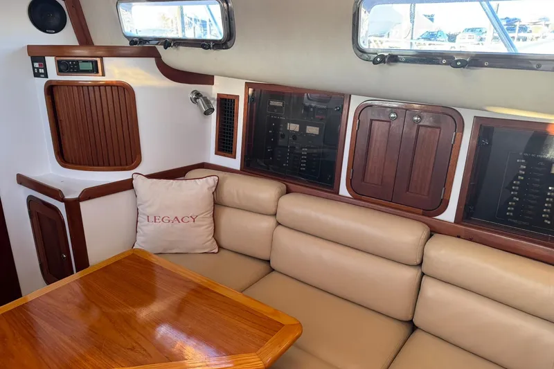 Slide: The Image of Interior of 2001 Legacy Soft Top boat with beige seating and wooden accents. - 29