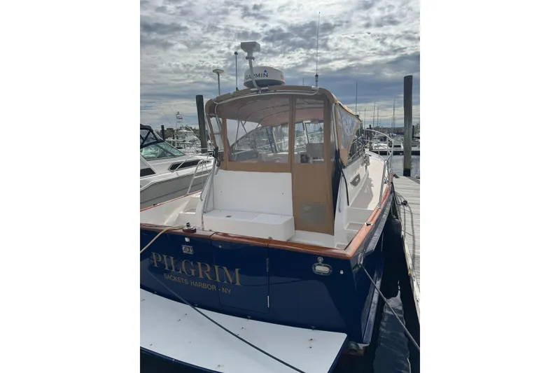 Slide: The Image of 2001 Legacy Soft Top boat docked at marina, named "Pilgrim," Sackets Harbor, NY. - 3