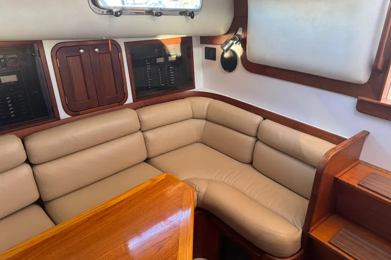 Slide: The Image of Luxurious 2001 Legacy Soft Top yacht interior with beige leather seating and wooden accents. - 30