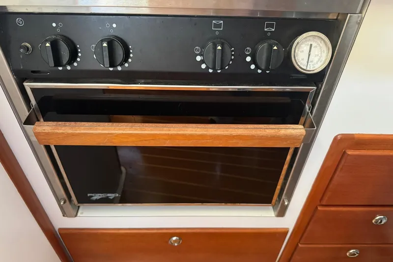 Slide: The Image of 2001 Legacy Soft Top oven with wooden handle and control knobs. - 34