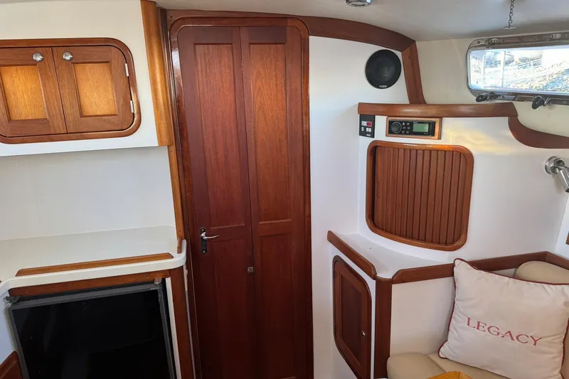 Slide: The Image of 2001 Legacy Soft Top boat interior with wooden cabinetry and Legacy-branded pillow. - 35