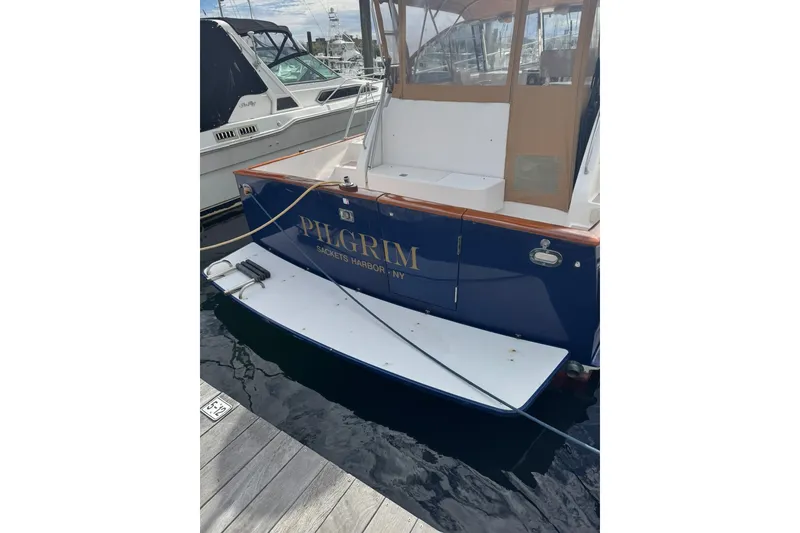 Slide: The Image of 2001 Legacy Soft Top boat named "Pilgrim" docked at Sackets Harbor. - 4