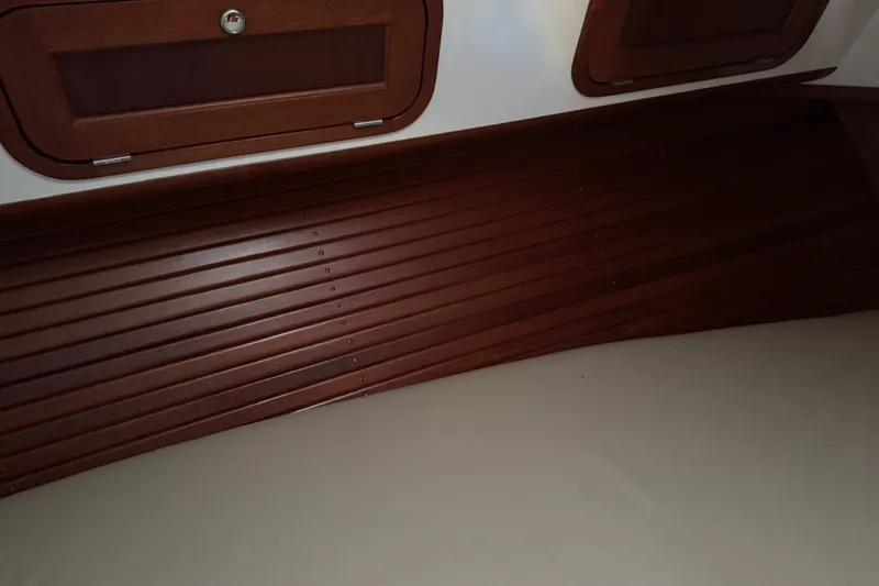 Slide: The Image of Interior of 2001 Legacy Soft Top boat with wooden paneling and storage compartments. - 40