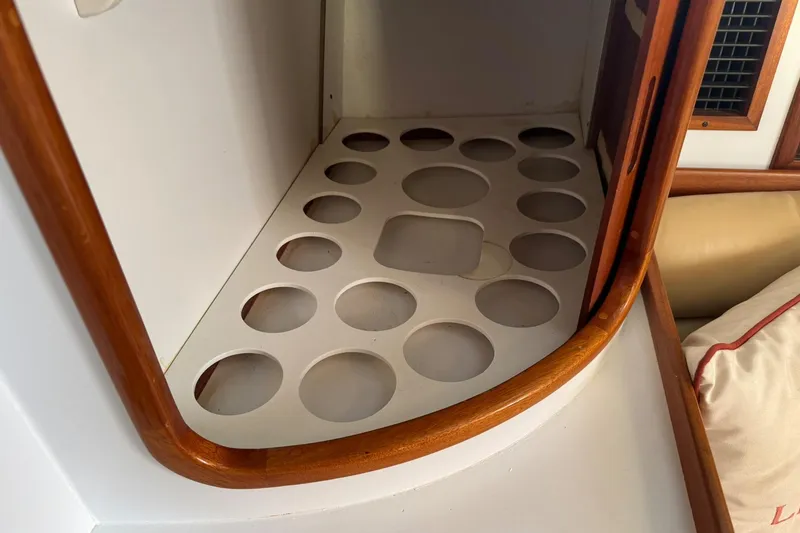 Slide: The Image of Storage compartment with circular cutouts in a 2001 Legacy Soft Top boat interior. - 41