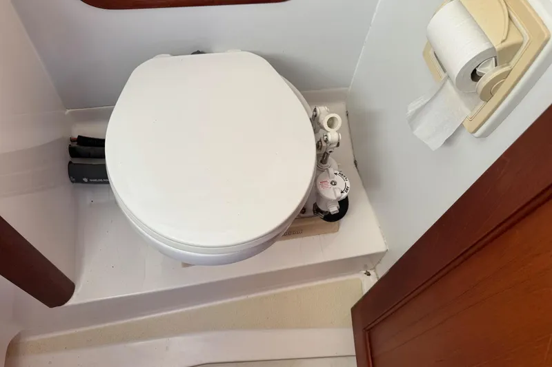 Slide: The Image of Boat bathroom with white toilet and toilet paper holder, Legacy Soft Top 2001 model. - 43