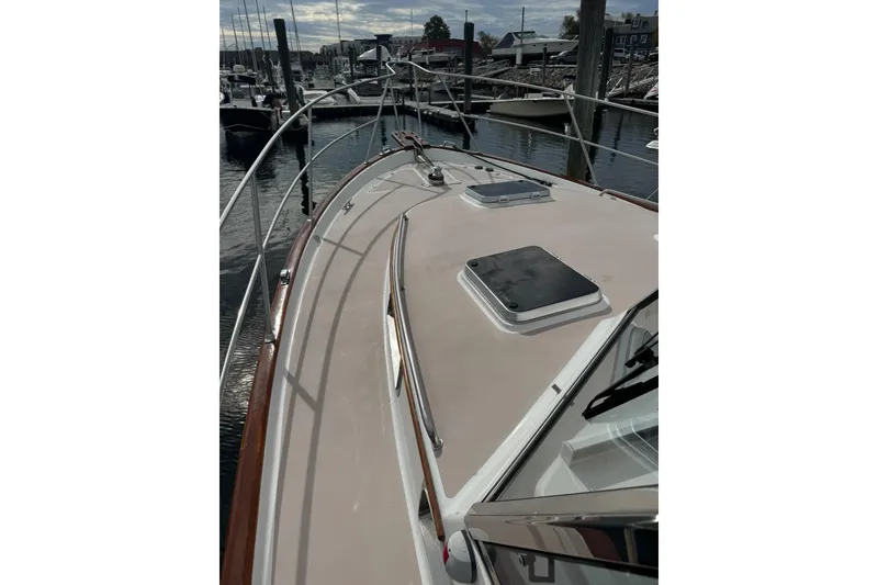 Slide: The Image of 2001 Legacy Soft Top boat deck with railing, docked at marina. - 6