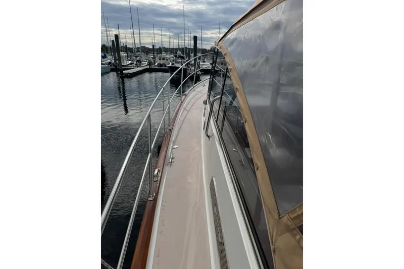 Slide: The Image of 2001 Legacy Soft Top boat docked at marina, showcasing sleek design and clear canopy. - 7