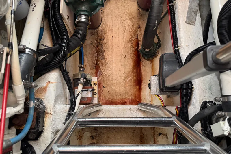 Slide: The Image of Engine compartment of 2001 Legacy Yachts Express, showing pipes and wiring. - 90