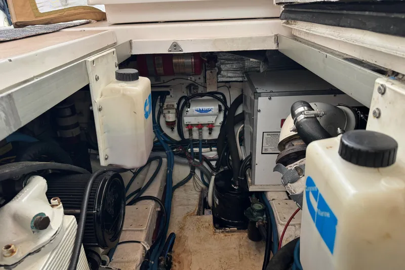 Slide: The Image of Engine compartment of 2001 Legacy Yachts Express, showcasing mechanical components and fluid reservoirs. - 92