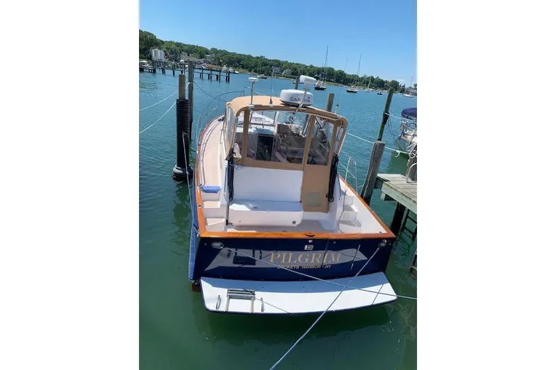Slide: The Image of 2001 Legacy Yachts Express docked in a serene marina setting. - 96