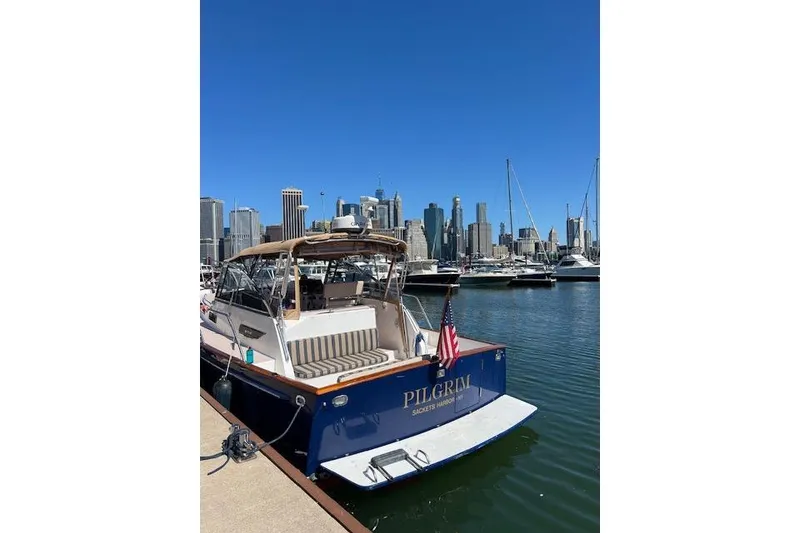 Slide: The Image of 2001 Legacy Yachts Express docked with city skyline in background. - 97