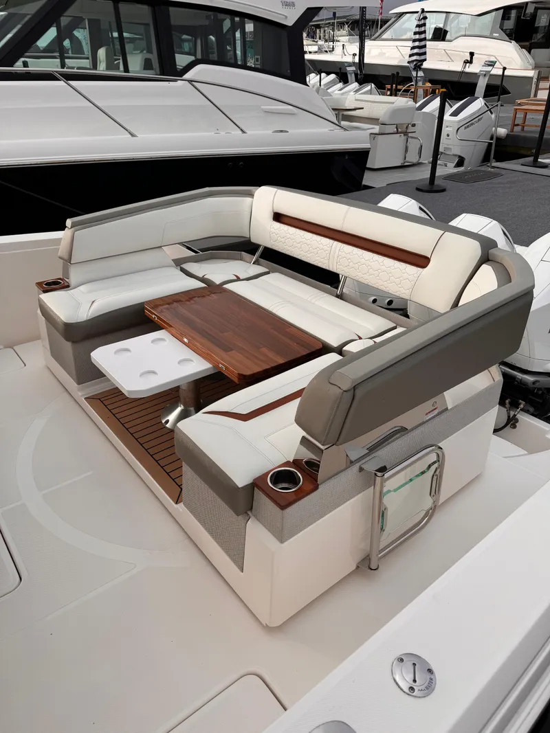 Slide: The Image of 2023 Tiara Yachts 38 LS luxury seating area with elegant wood table and plush cushions. - 8