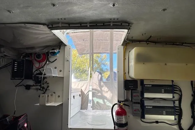 Slide: The Image of Interior view of a 2001 Dusky 252 CSS boat, showcasing equipment and wiring. - 11