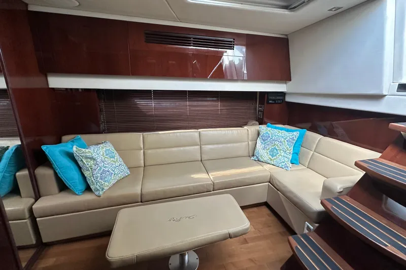 Slide: The Image of Luxurious interior of 2011 Sea Ray 470 Sundancer with beige leather seating and decorative pillows. - 12