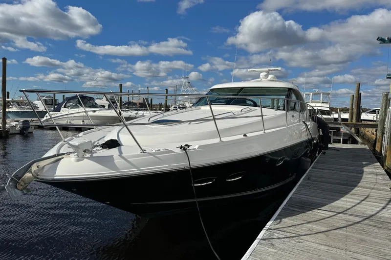 Slide: The Image of 2011 Sea Ray 470 Sundancer yacht docked at marina under blue sky. - 14