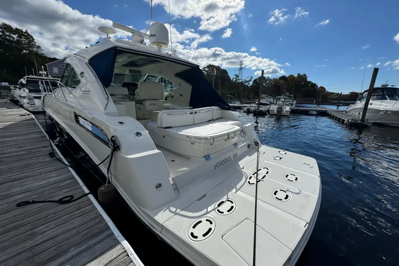Slide: The Image of 2011 Sea Ray 470 Sundancer yacht docked at marina under blue sky. - 15