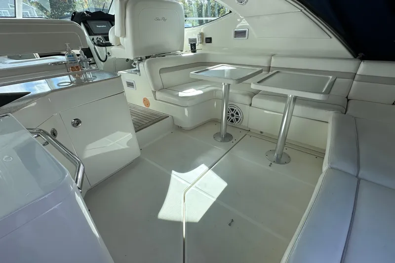 Slide: The Image of Interior of 2011 Sea Ray 470 Sundancer yacht with white seating and tables. - 3