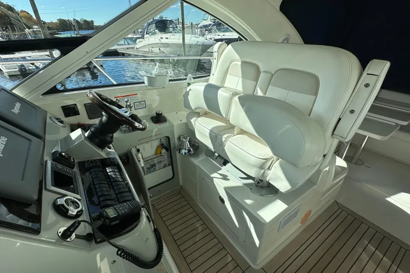 Slide: The Image of 2011 Sea Ray 470 Sundancer helm with dual seats and modern controls. - 7