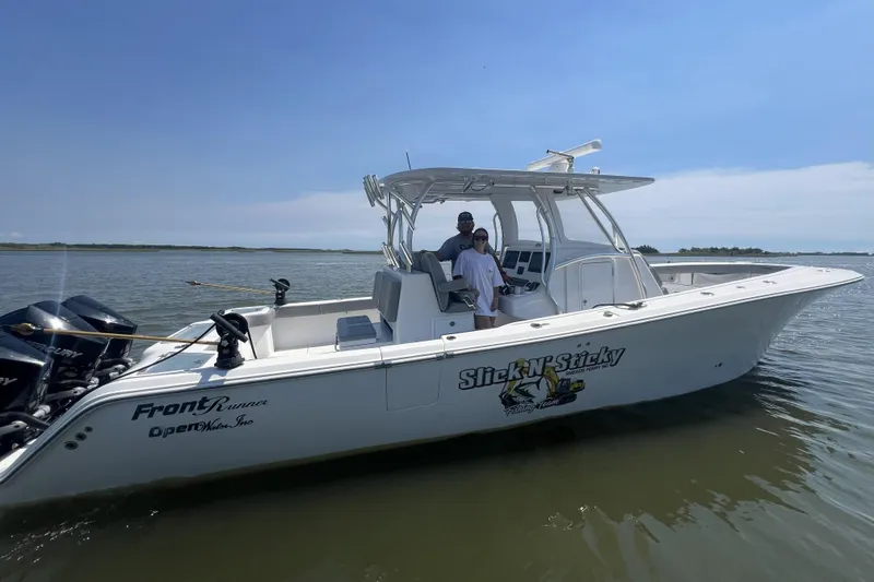 The Image of 2023 Front Runner 36 cc boat on water, featuring "Slick N' Sticky" graphics. - 0