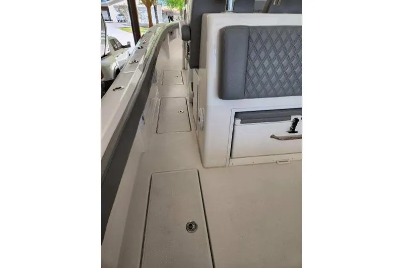 Slide: The Image of 2023 Front Runner 36 cc boat interior with cushioned seating and storage compartments. - 11