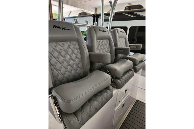 Slide: The Image of 2023 Front Runner 36 cc boat seats with gray diamond-stitched upholstery and armrests. - 12
