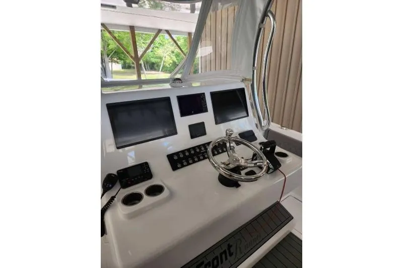 Slide: The Image of 2023 Front Runner 36 cc boat dashboard with steering wheel and electronic displays. - 14